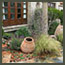 CA Mediterranean garden with Corylus avellana ‘Contorta’, antiwue olive jar, Spanish lavendar in Los Angeles.
