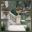 CA Italian garden terrace with fountains, travertine patio, Italian urns, agaves, red geraniums near Pasadena.