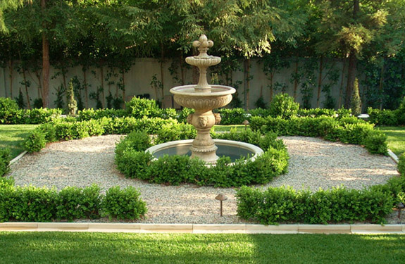 CA Italian garden terrace with fountains, travertine patio, Italian urns, agaves, red geraniums near Pasadena.