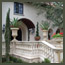 CA Italian garden front entry with native oak tree, balustrades, Italian Cypress, and Italian urns near Pasadena.