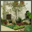 Spanish home with CA garden design includes Red bananas, New Zealand flax, 